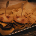 Classic slider served with potato chips at novi axe throwing near me.