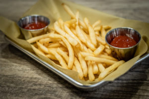 French fries served in a try with Ketchup at the Legendary Axe detroit.
