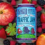 Blake’s Hard Cider Triple Berry Traffic Jam Can with apple and berries in background.